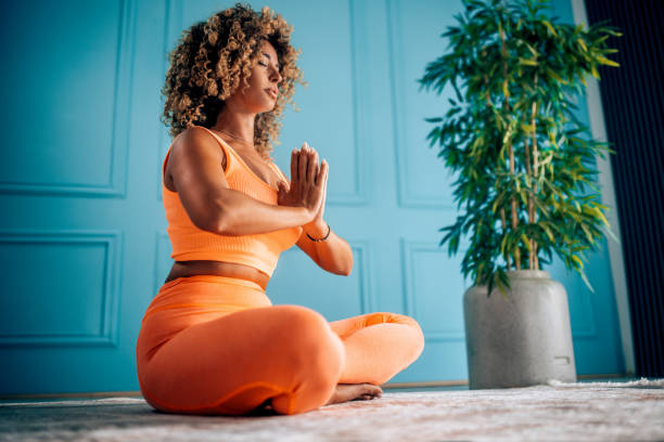 Young Woman Practicing Breathing Exercise At Home