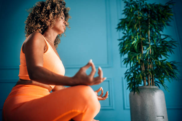 istock Young Woman Practicing Breathing Exercise At Home 2166552188