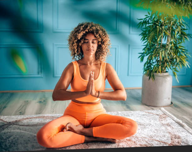 istock Young Woman Practicing Breathing Exercise At Home 2166552197