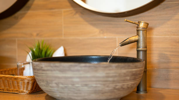 istock Luxury designed brass faucet with water flowing. 2166554449