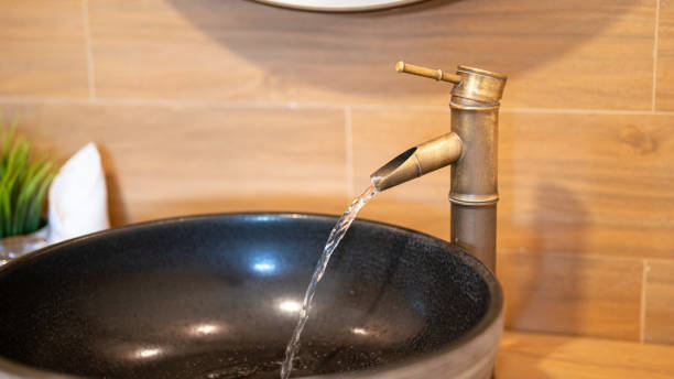 istock Luxury designed brass faucet with water flowing. 2166554466