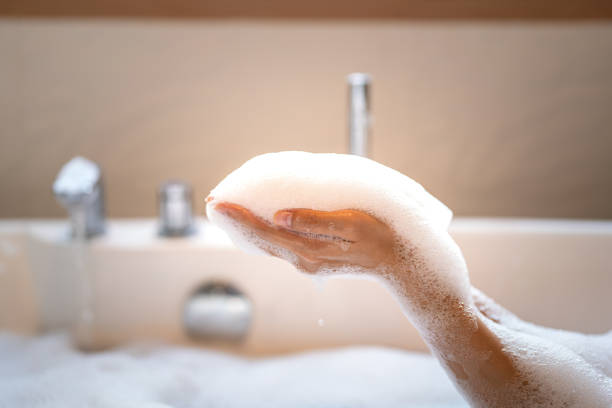 istock People hand is playing shower soap foam bubbles. 2166554482