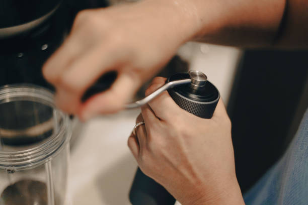 istock Close-up woman hand is grinding coffee beans. 2166556904