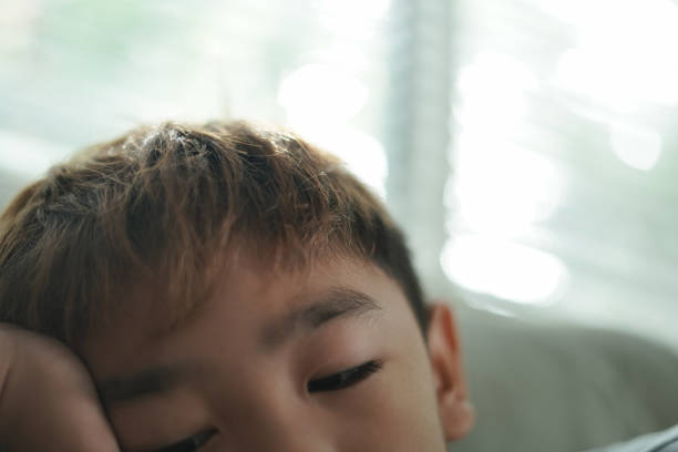 Close-up face Boy looking at his mobile phone.