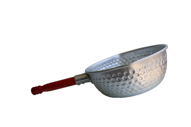 istock A silver pan with a wooden handle sits on a white background. The pan is empty and has a circular shape 2166557467