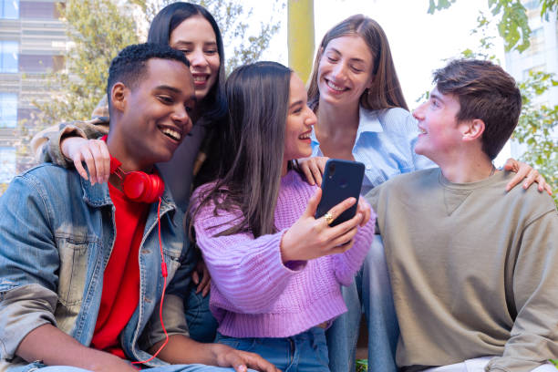 istock Five students having fun with mobile phones creating content on social media. 2166559284
