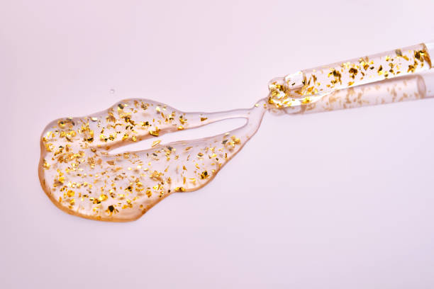 istock Pipette with 24k gold serum on a pink background. 2166559700