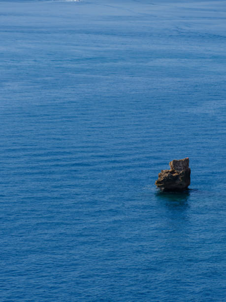 istock blue sea and beautiful rocks 2166559853