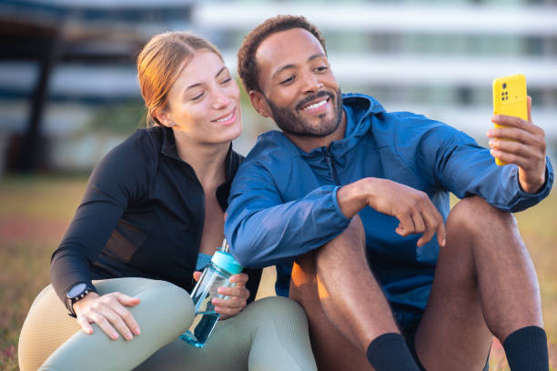 istock Happy young couple taking a selfie with their smartphone ready to exercise. 2166561067