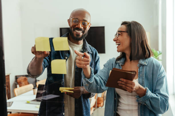 istock Creative business team brainstorming ideas with sticky notes in modern office 2166563137