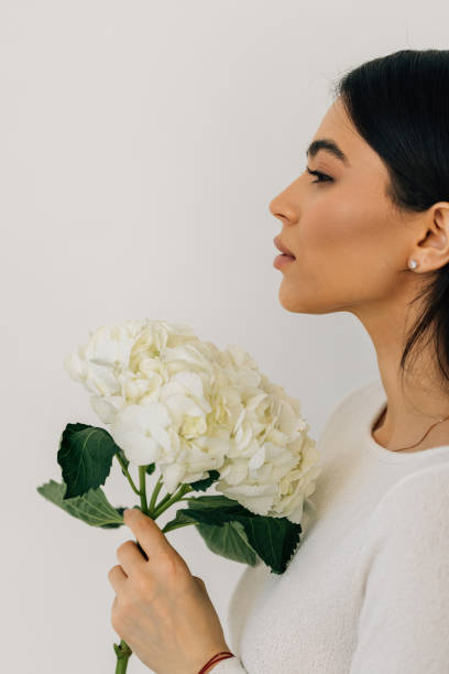istock Young woman hold blue hydrangea flower bouquet on white background. 2166563313