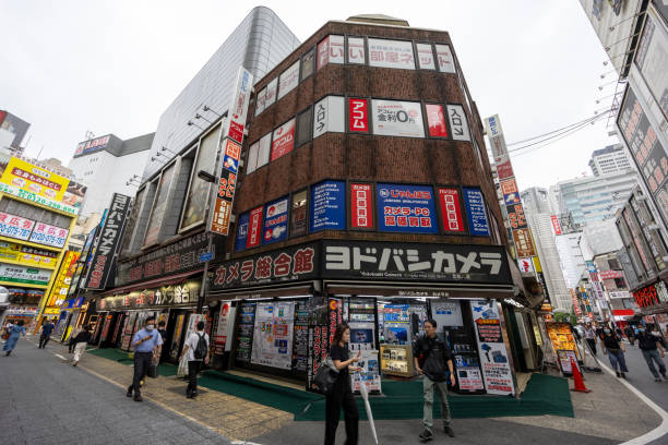Tokyo, Japan - May 27, 2024 : Pedestrians walk past the Yodobashi Camera in Shinjuku, Tokyo, Japan.
