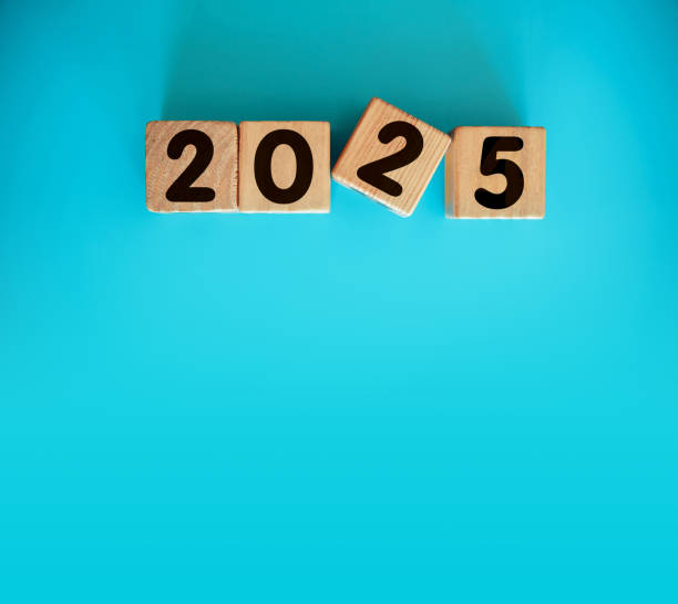 istock New Year 2025 with wood block isolated on blue background 2166563961