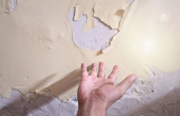 istock Man upset with damaged peeling of wall 2166565512