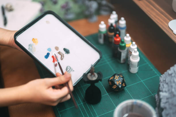 istock Hand using brush paint acrylic colour to miniatures for tabletop role playing game or board games 2166566057