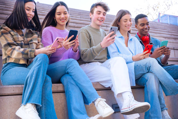istock Five students having fun with mobile phones creating content on social media. 2166566281