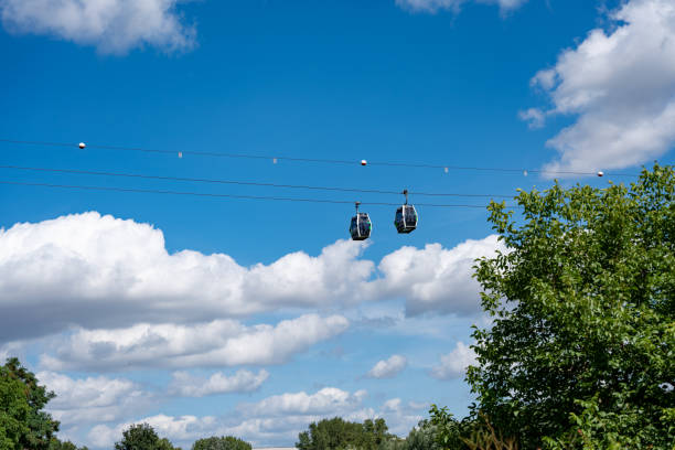 istock Two cable cars are flying through the sky above a forest 2166569329