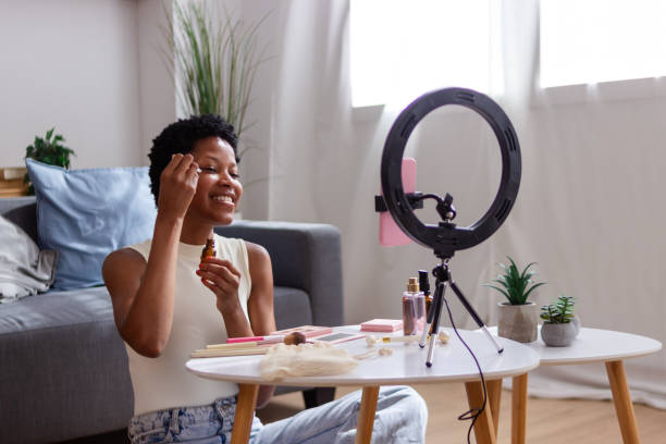 istock Beauty influencer applying makeup and creating content for social media with a ring light 2166570866