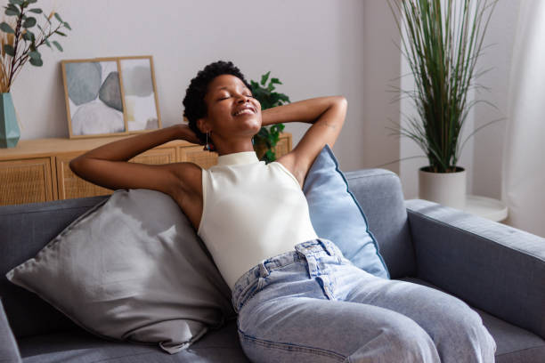 istock Young woman relaxing on comfortable couch at home 2166570886