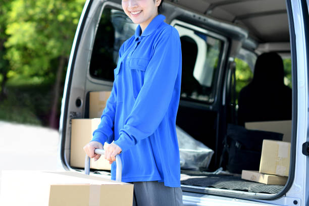 istock Asian female delivery driver carrying luggage 2166571490