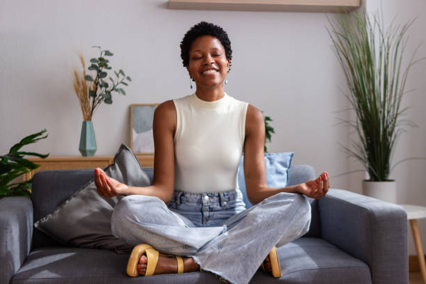 istock Serene young woman practicing yoga meditation at home 2166571653