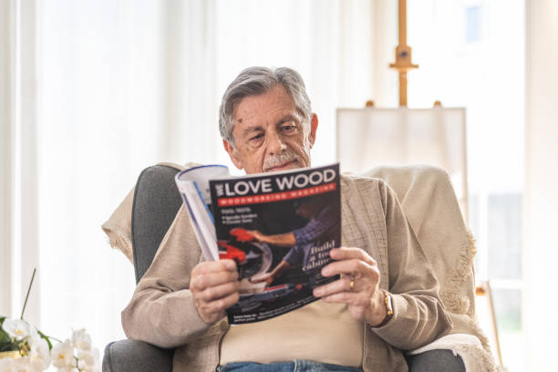istock Senior Man Enjoys Relaxing Read in Living Room 2166571676
