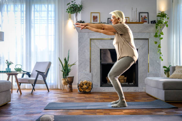 istock Senior Woman Exercising at Home 2166571699