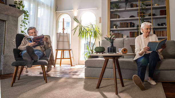 istock Elderly Couple Engaged in Reading at Home 2166571715