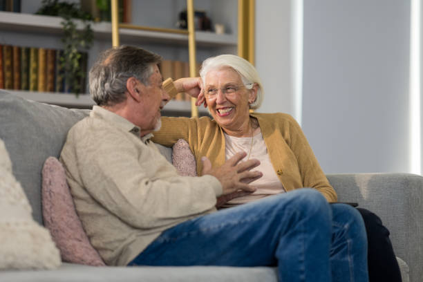 istock Elderly Caucasian Couple Enjoying Conversation on Couch 2166571720