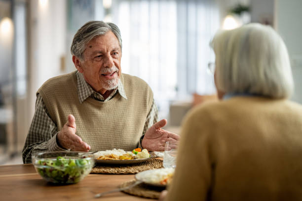 istock Senior Couple Dines at Home 2166571735