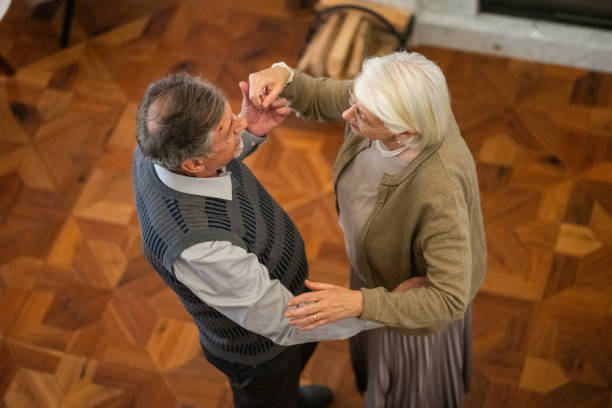 istock Senior Couple Dancing in Living Room 2166571788