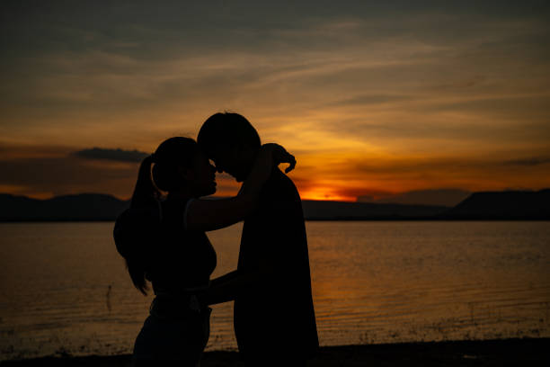 istock A couple is hugging each other on a beach at sunset 2166572536