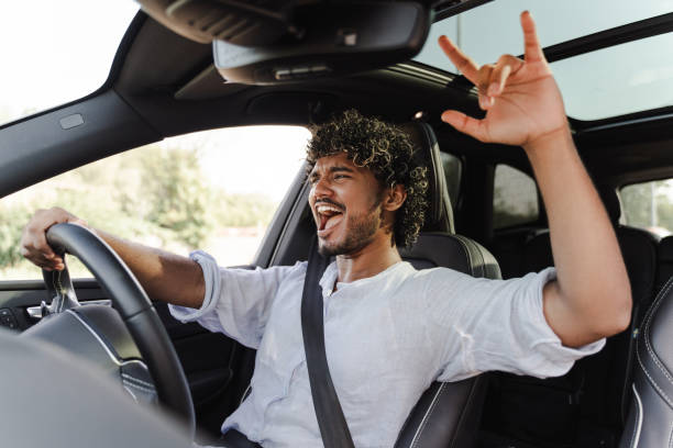 istock Excited, Indian man singing and enjoying while driving car 2166572594