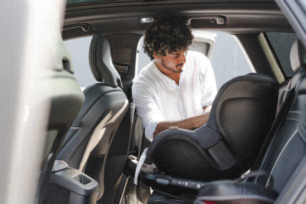 istock Father installing a child safety seat in his car 2166572620