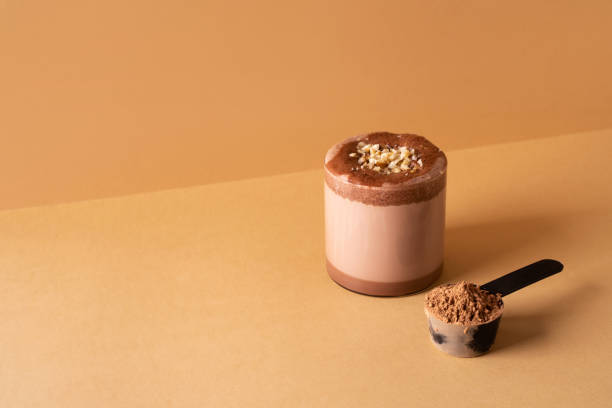 istock Protein chocolate cocktail drink in glass on brown background 2166578326