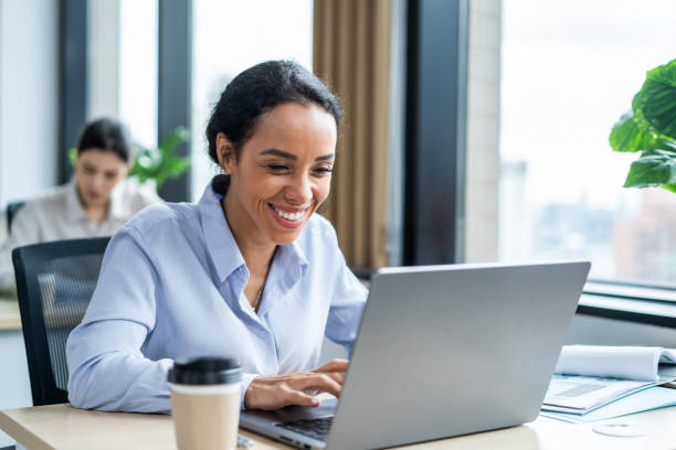istock Latino beautiful businesswoman using laptop computer working in office. Attractive young professional female employee sitting on table, feeling happy and relax, enjoy successful in corporate workplace 2166578439
