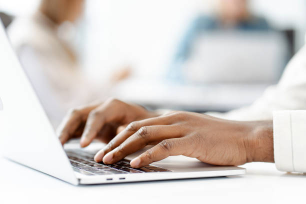 istock Manager typing on laptop keyboard in busy office, selective focus on hands 2166579507
