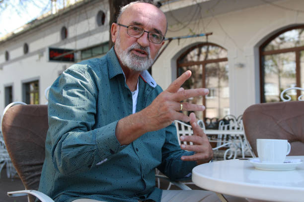 istock Senior man relaxing in coffee shop 2166580855