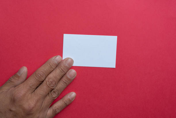 Young businessman holding a blank card for your message