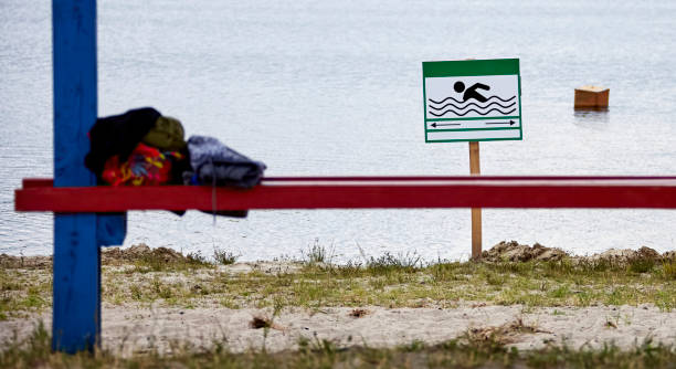 istock Sunny lakeside bench inviting swimmers and sunbathers on a warm summer day 2166582119