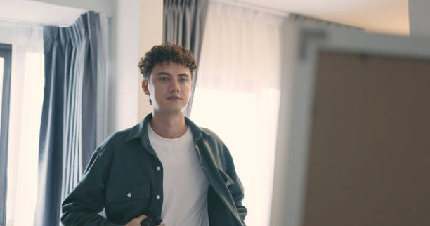 istock Man Dressing Up in Front of Mirror. 2166582233