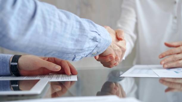 istock Business people shaking hands over contract agreement and financ 2166582869