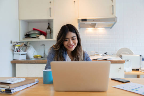 istock Young Woman Freelancer Working from Home on Laptop in Modern Kitchen, Remote Work, Home Office, Technology, Lifestyle 2166583458