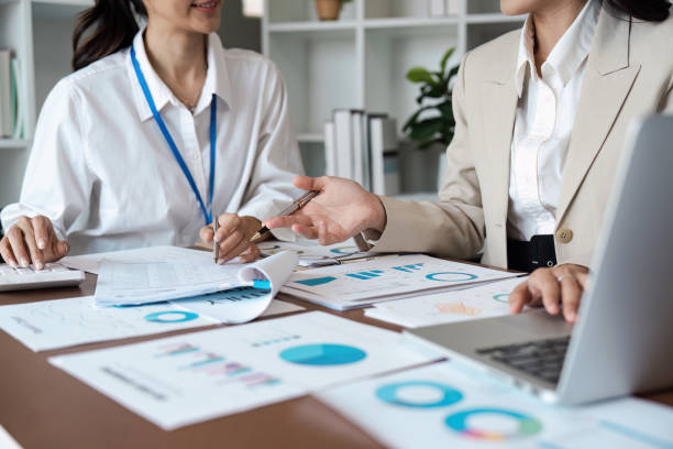 istock Business Meeting with Colleagues Discussing Financial Reports and Analyzing Data in a Modern Office Setting 2166583523