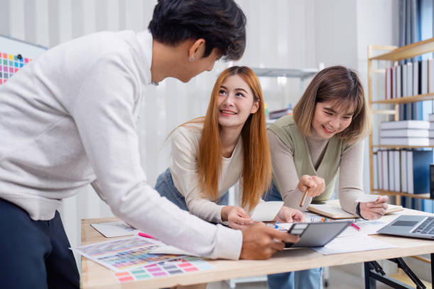istock Creative Team Collaborating on UX/UI Design Project in Modern Office Environment 2166583574