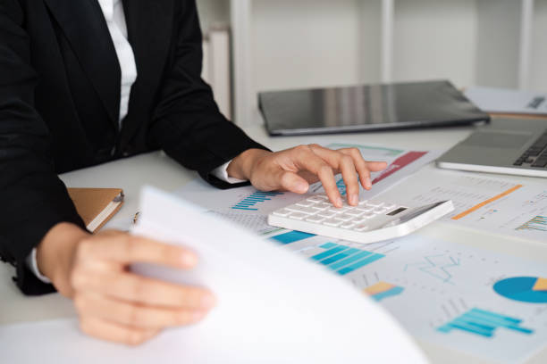 istock Professional Accountant analysis Financial Reports and Using Calculator in Modern Office Setting 2166583684