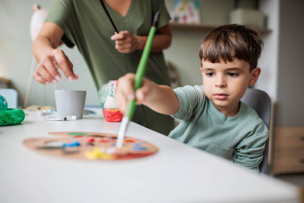 istock Boy making a solar system model at home with his mother 2166584549