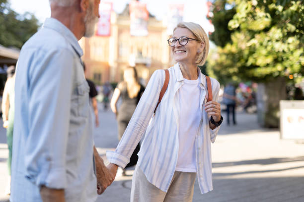 istock Elderly couple strolling in urban setting holding hands 2166586661