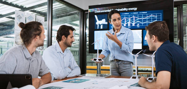istock Engineer team brainstorm meeting in factory office. Presentation on ESG project planning, solar panel, wind turbine power generation, environmental sustainable energy efficient. Industrial business 2166587217