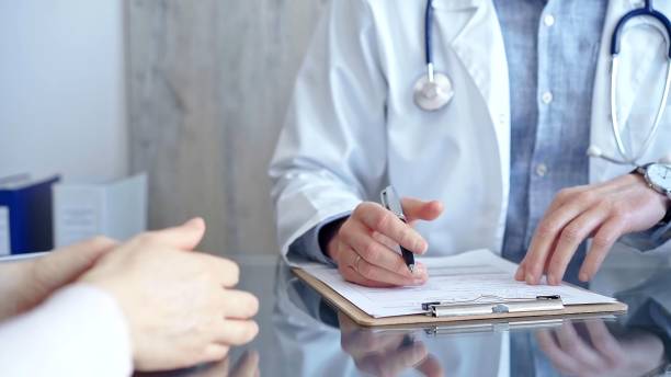 istock Doctor and patient conversation with clipboard in clinic office. Physician is making notes while listening woman. Medicine and Health care 2166588844